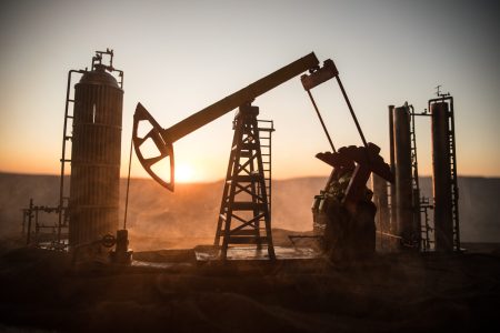 Creative artwork decoration. Oil pump and oil refining factory at sunset. Energy industrial concept. Selective focus. Oil pump and oil refining factory at sunset. Energy industrial concept. Selective focus. Creative artwork decoration.